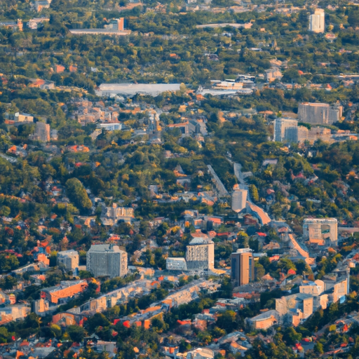 צילום אוויר של עיר שוקקת, המציג את הפיתוח העירוני והשפעתו על השימוש בקרקע.